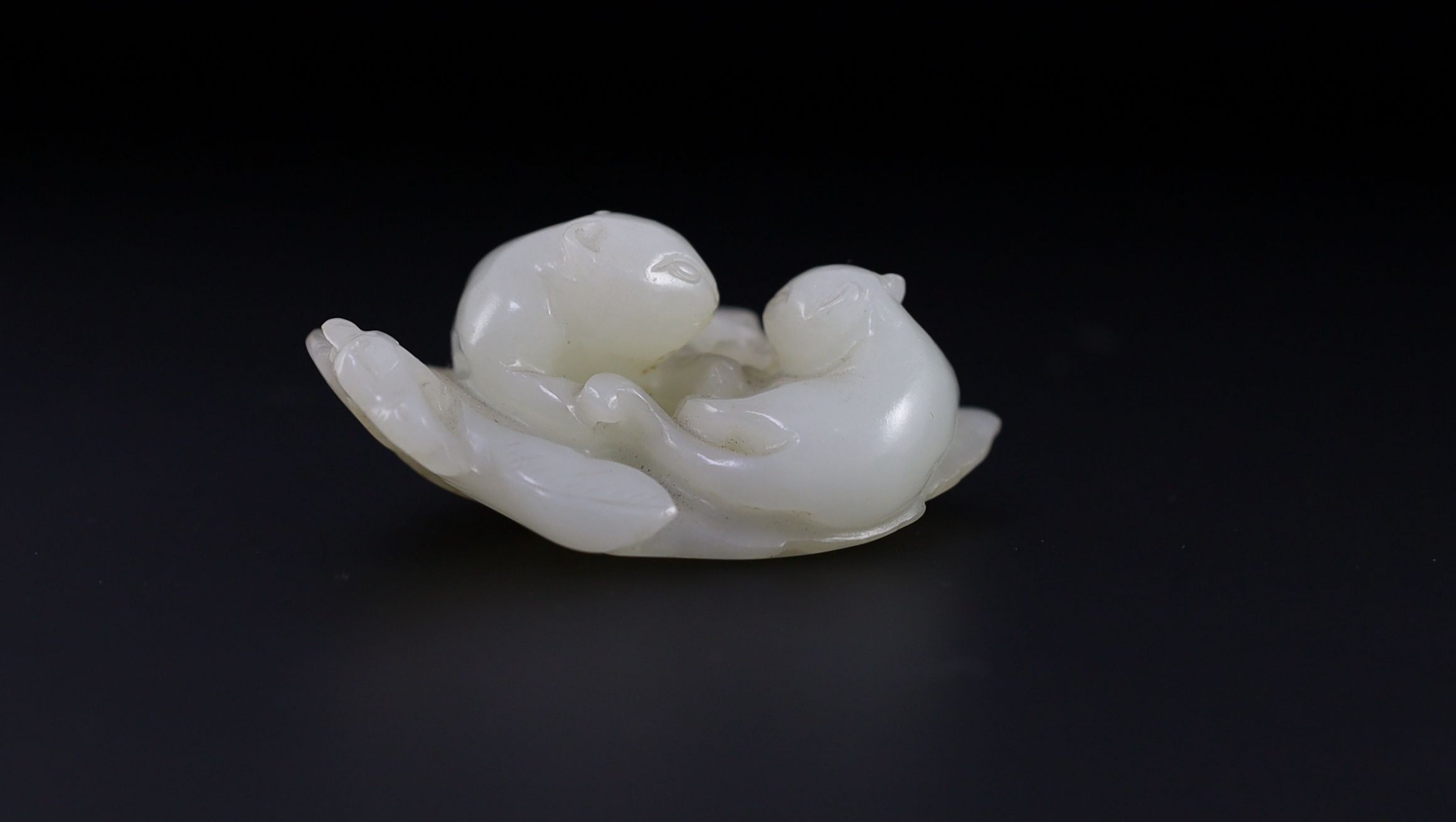A Chinese pale celadon jade ‘cats and butterfly’ group, 18th/19th century, 6cm long